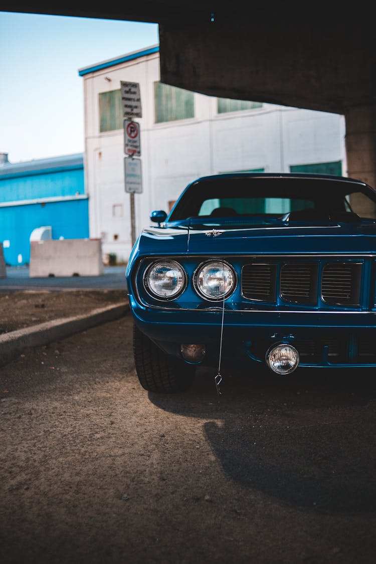 Retro Car With Headlights On Concrete Parking