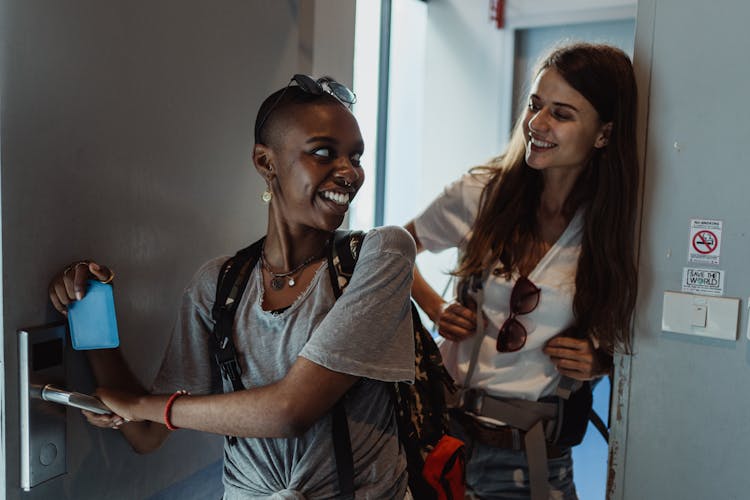 Smiling Women Entering Room