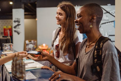 Free Women Receiving A Hotel Room Card At The Reception Desk  Stock Photo