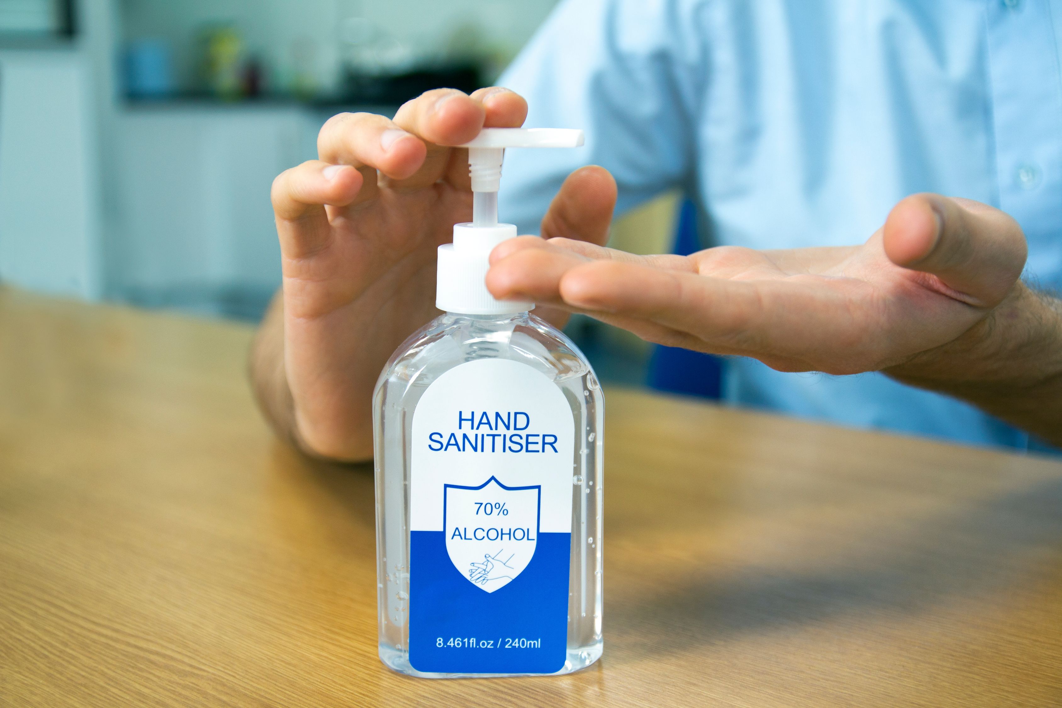 Person Holding Hand Sanitizer Bottle Free Stock Photo person-holding-hand-sanitizer-bottle-free-stock-photo
