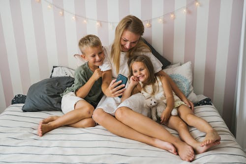 A Woman with her Children Using the Smartphone Together