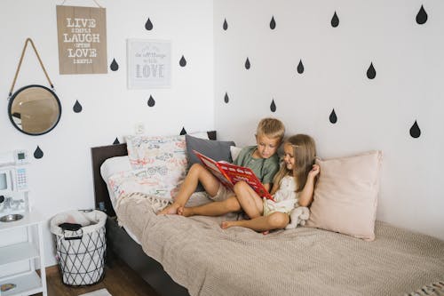 Photograph of Siblings Reading a Book Together