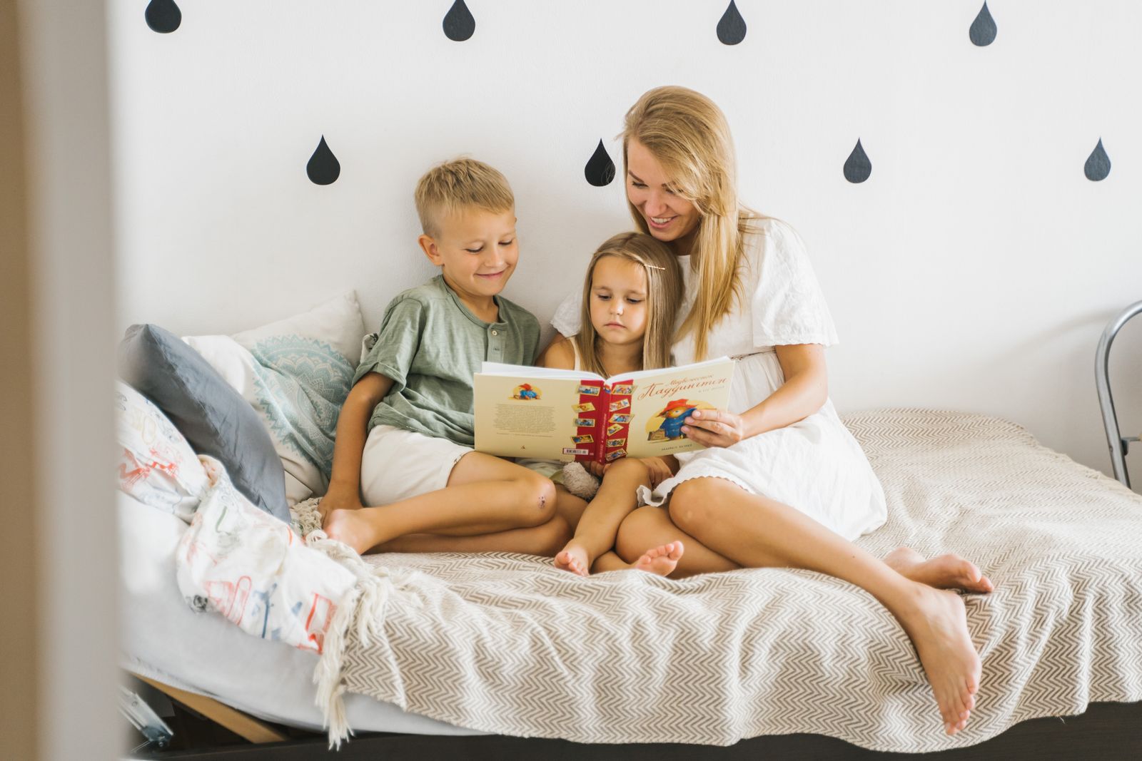 Mother reading a book aloud to her two children during homeschool morning time