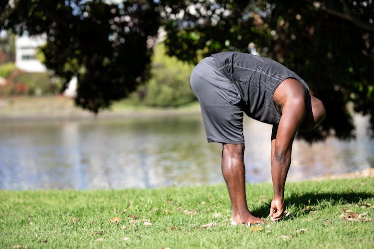 A Man Stretching In The Park