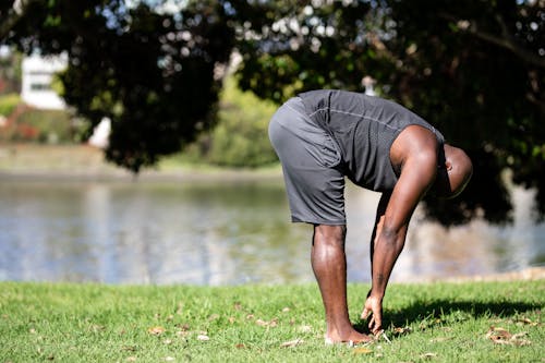 Man in Gray Tank Top Doing Stretching