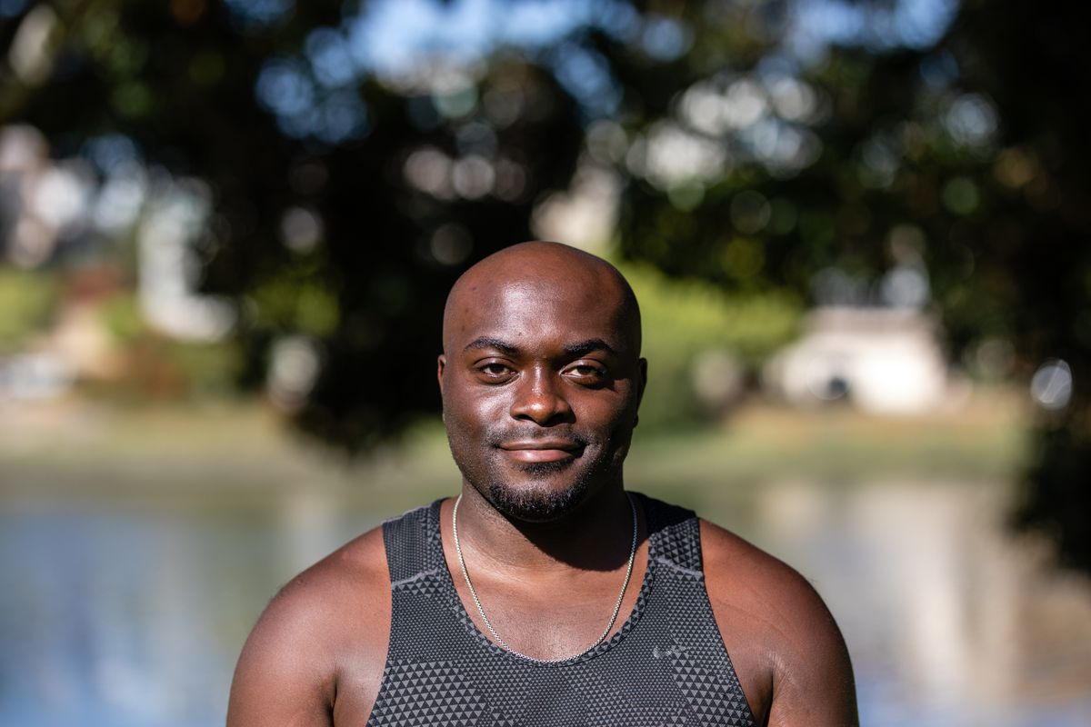 Black African man smiling outdoors – heart health and cholesterol management Nigeria