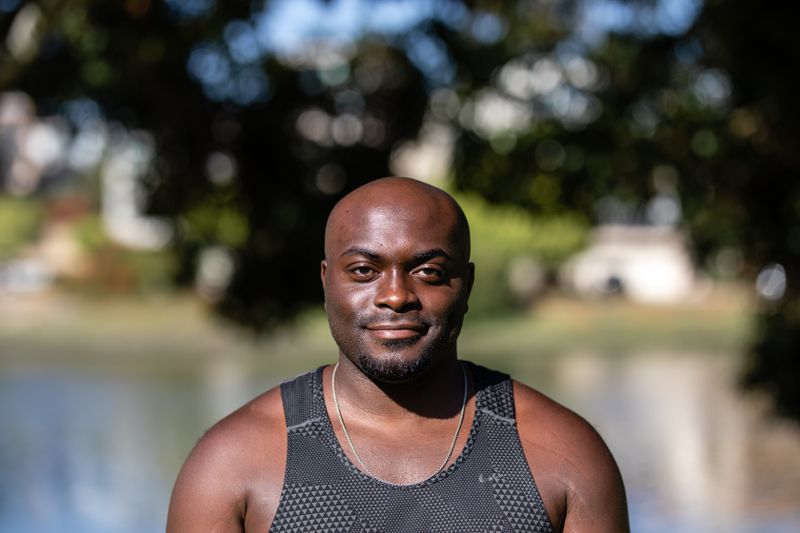 Black African man smiling outdoors – heart health and cholesterol management Nigeria
