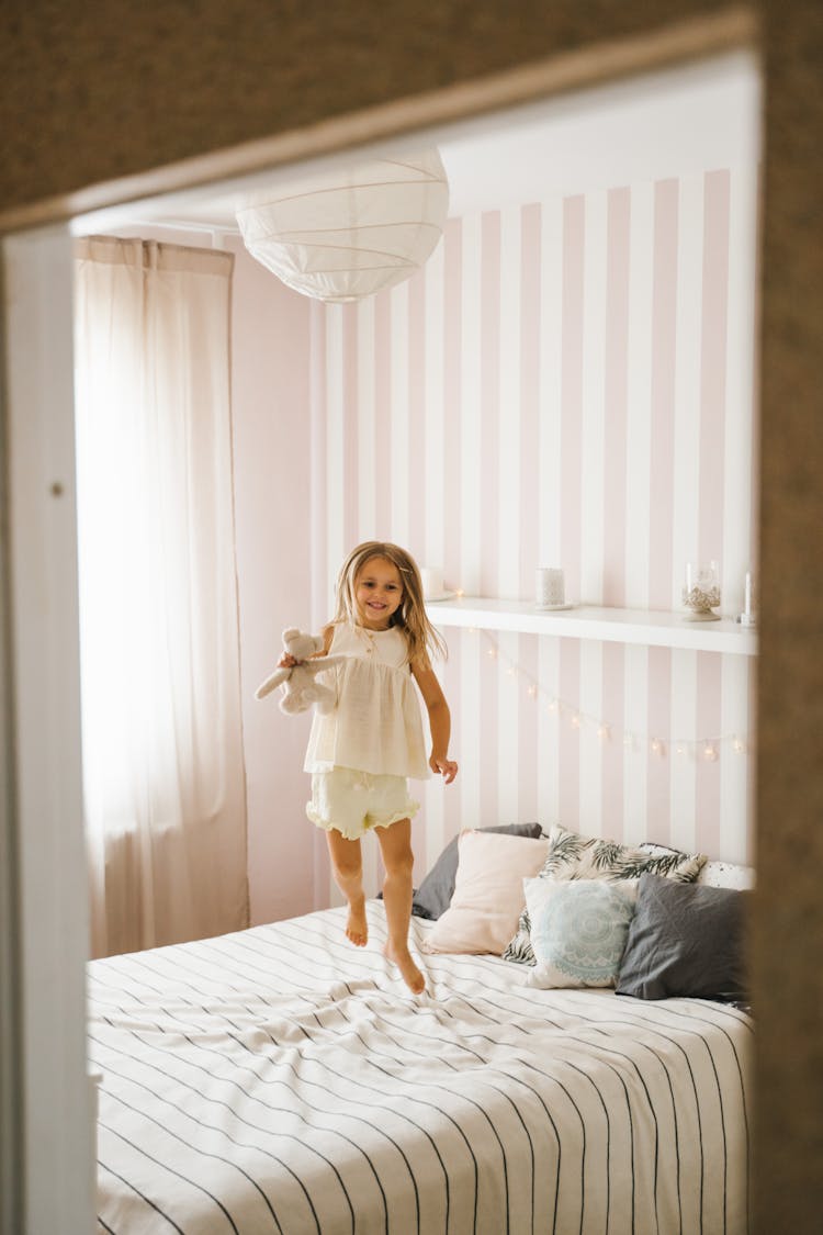 A Girl Jumping On The Bed