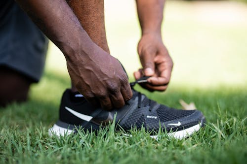 Free Close Up Photo of a Person Tying Shoelaces Stock Photo