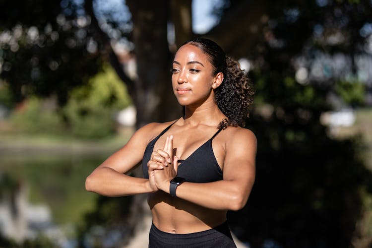 Woman In Black Sports Bra Meditating