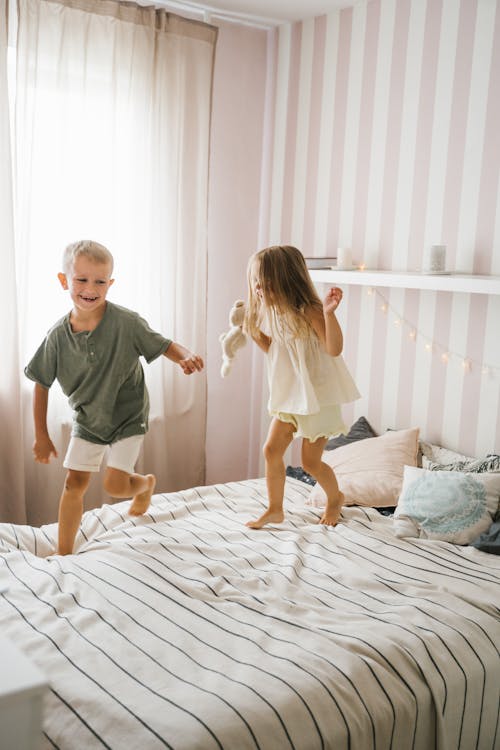 Free Kids Playing on the Bed Stock Photo