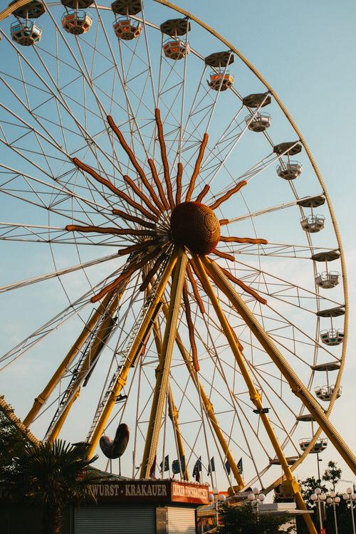 Free Ferris wheel in theme park during sunset, offering a warm and adventurous experience. Stock Photo
