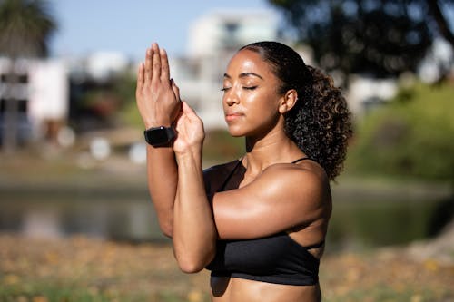 Woman in Black Sports Bra Meditating