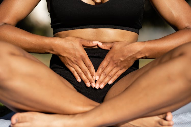 Sitting Woman With Hands On Stomach