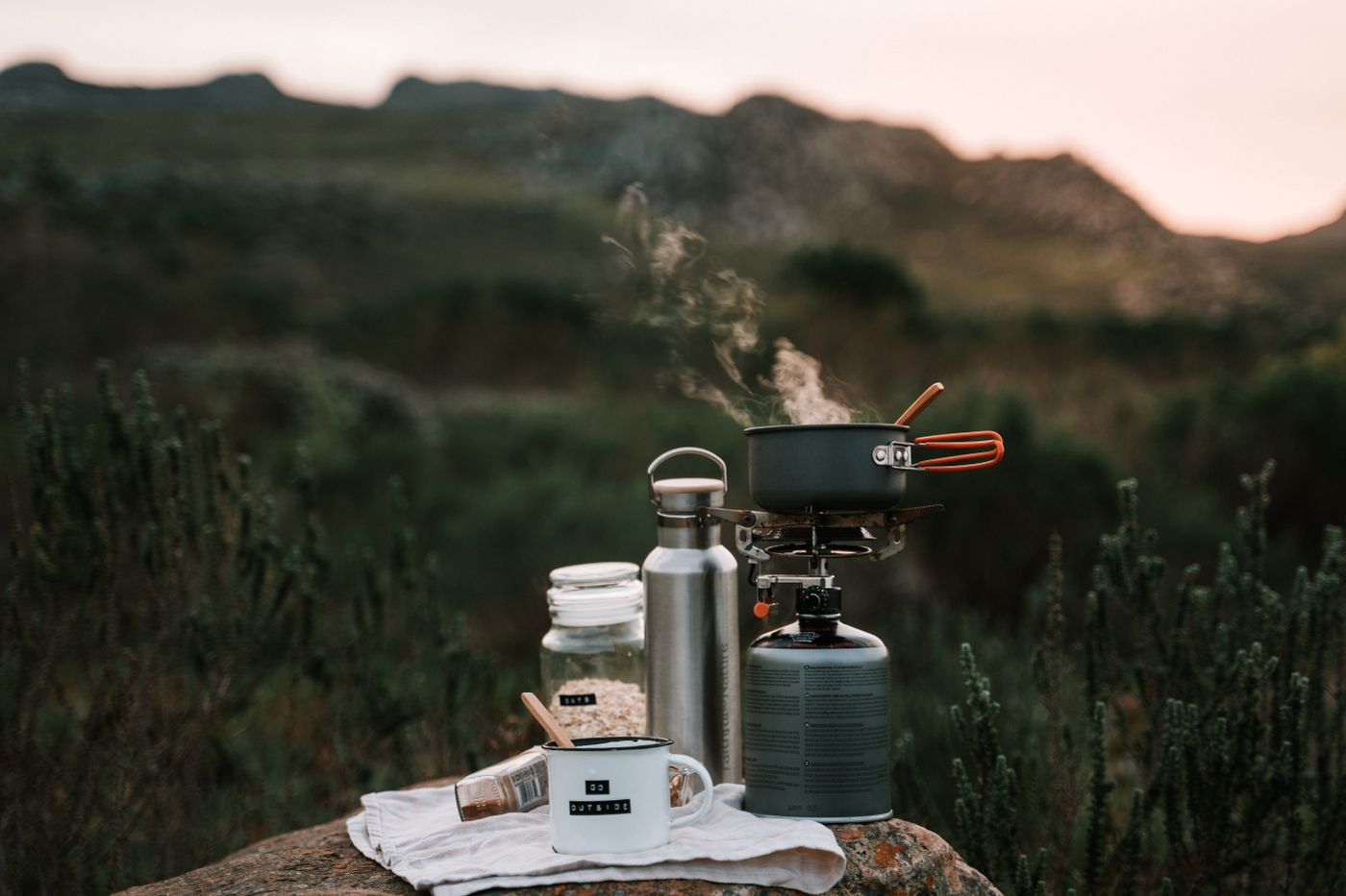 Camping cooking kit on a rock