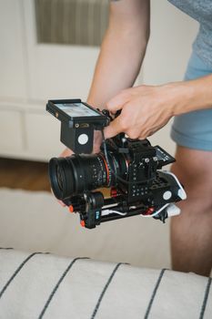 A detailed view of hands holding a professional camera rig, perfect for video production.