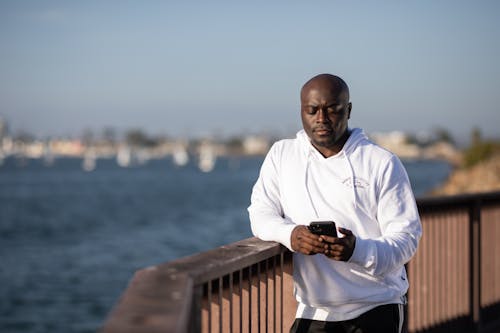 Person Wearing Hoodie Holding a Cellphone