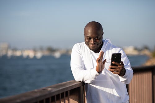 Free Man Wearing White Hoodie on a Video Call Stock Photo