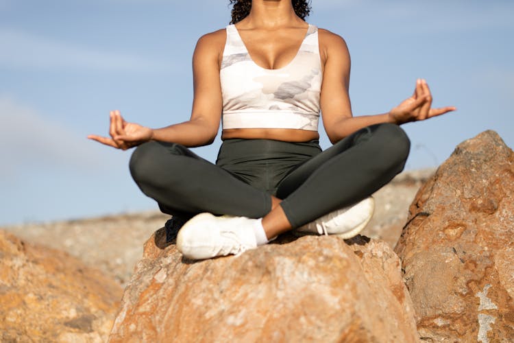 A Woman Sitting On A Rock