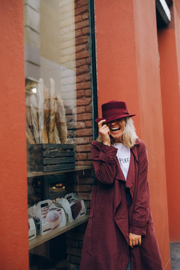 A Woman Wearing A Hat And Long Coat