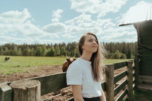 Woman in White T-shirt Standing Beside Brown Horse