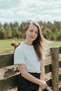 Girl in White Crew Neck T-shirt Sitting on Brown Wooden Bench