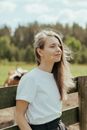 Woman in White Crew Neck T-shirt Wearing Silver Framed Eyeglasses