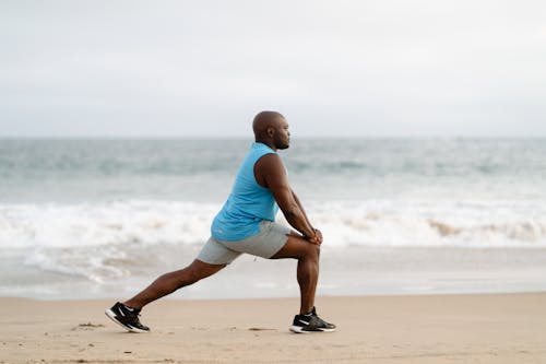 Man on Shore doing Stretching Exercises