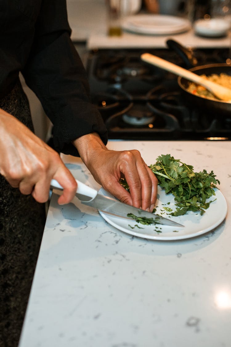 A Person Chopping Parsley