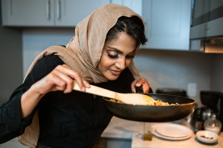 A Woman Smelling Her Cooking