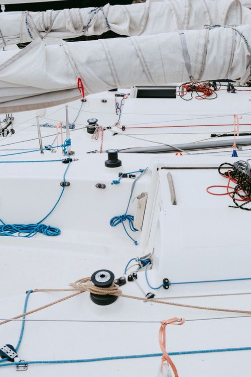 Free Detailed view of yacht deck with ropes and rigging, showcasing nautical equipment without people. Stock Photo