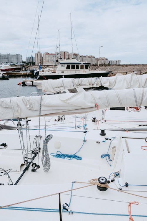 White and Blue Sail Boat on Sea Dock