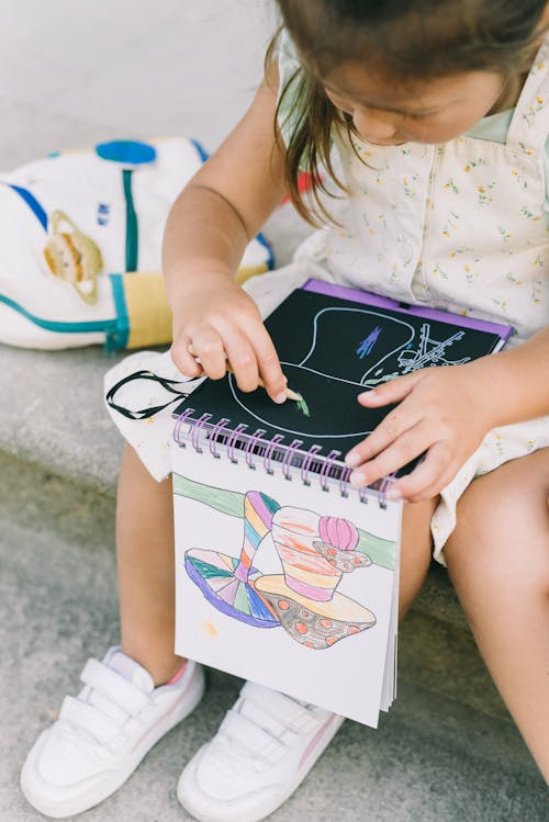 A Close-Up Shot of a Girl Coloring