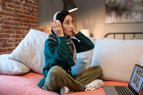 Woman listening on White Headphones 