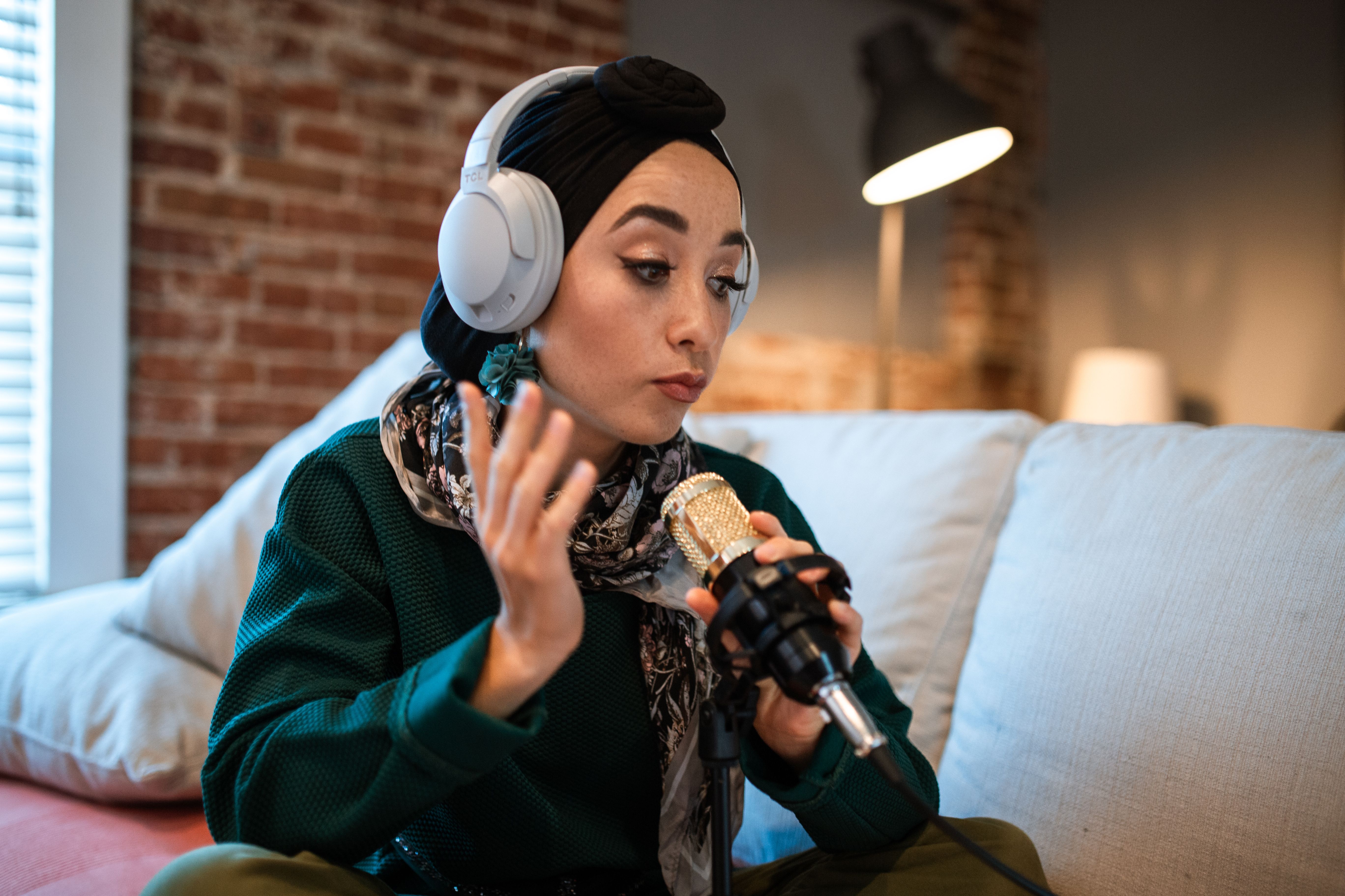 A person wearing headphones and speaking into a microphone