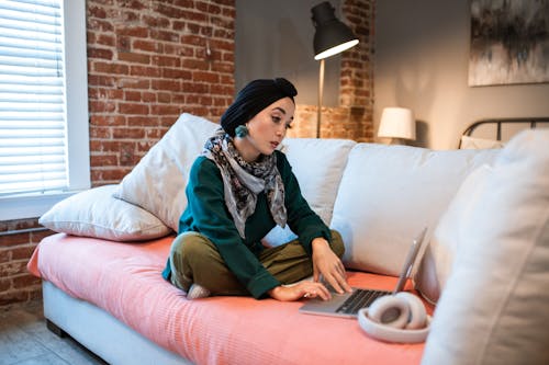 Woman using Laptop on Couch
