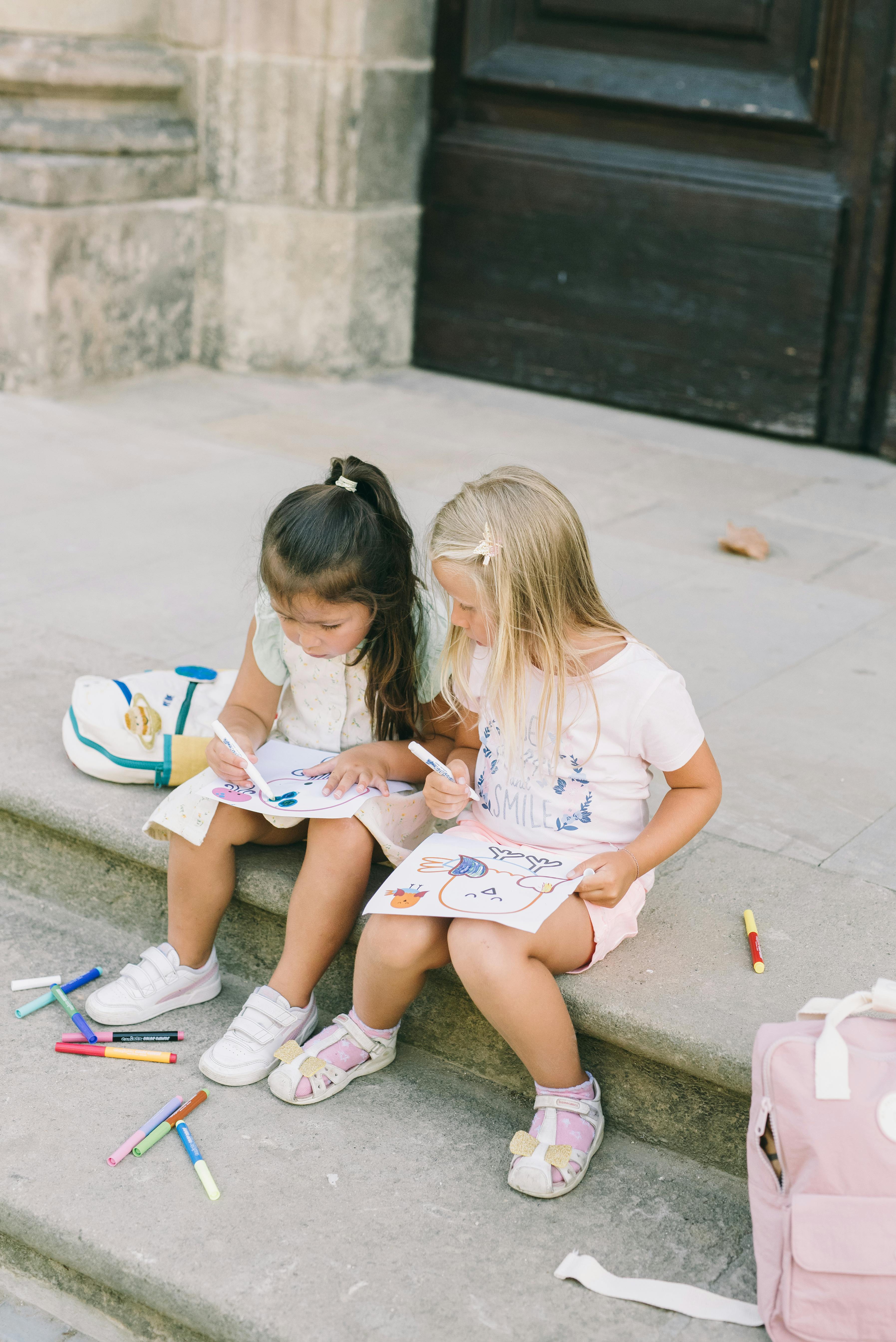 girls drawing on steps