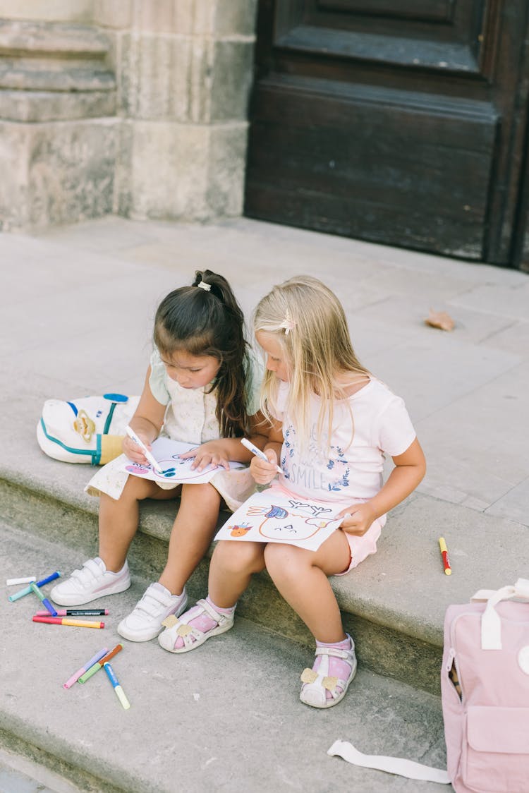 Girls Drawing On Steps