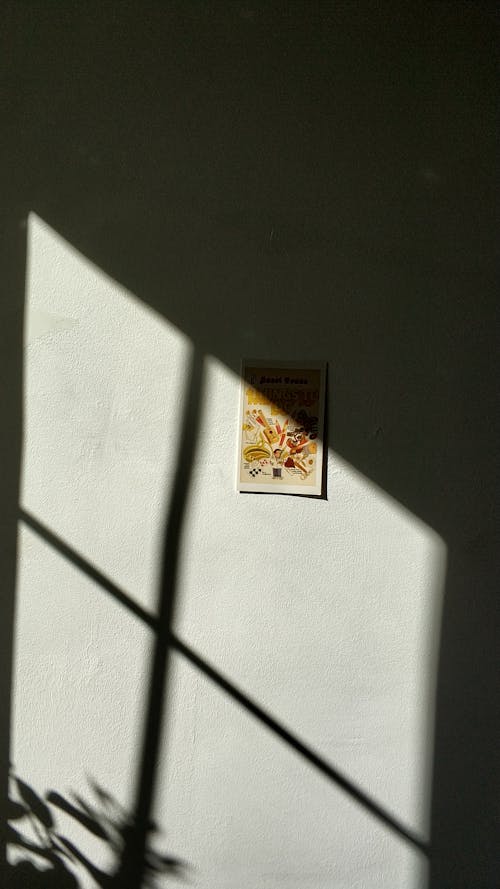 Shadow from window on wall with picture