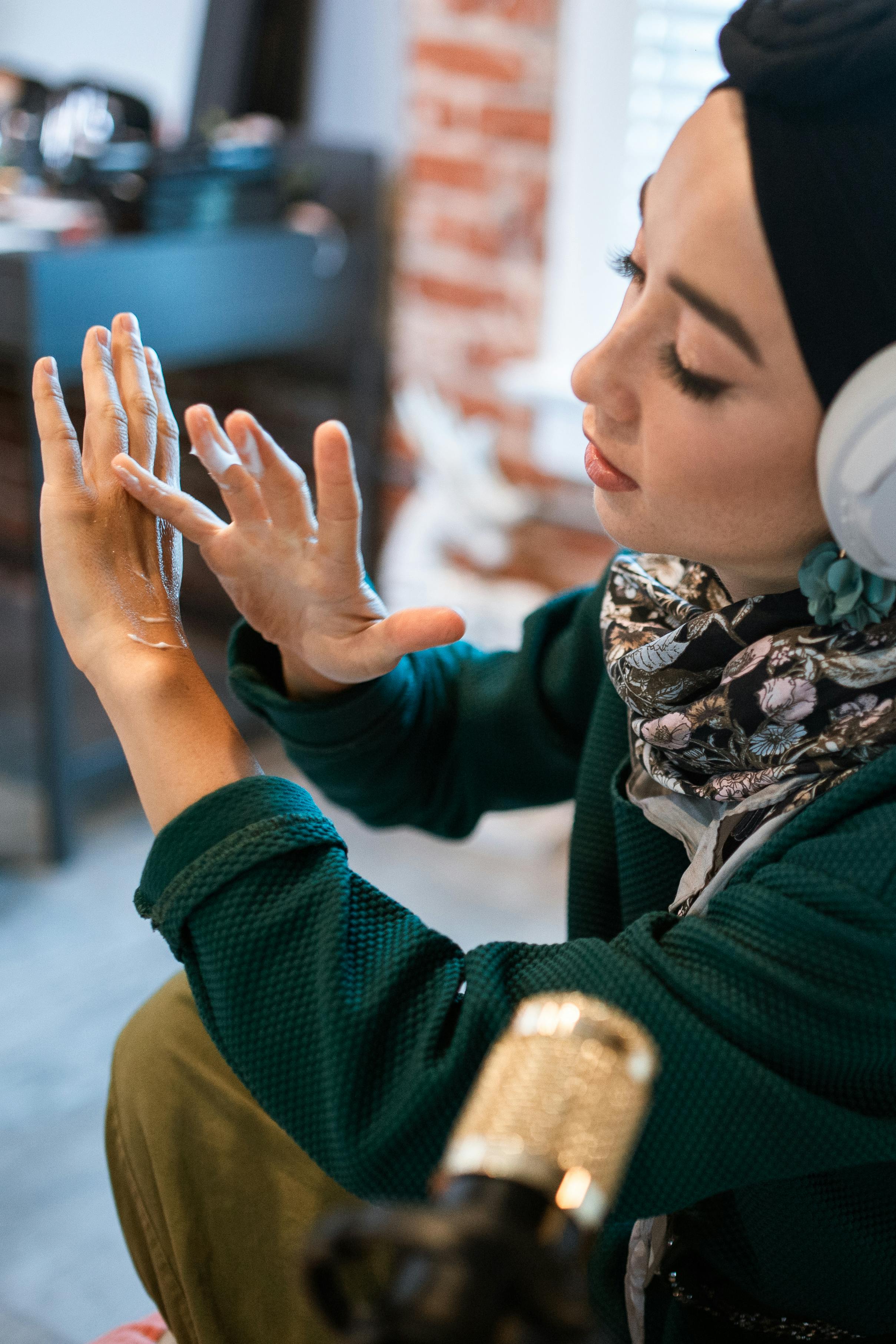 Focused woman with headphones vlogging indoors, showcasing modern lifestyle.