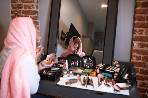 Free Woman in Pink Headscarf  Applying Blush On Stock Photo