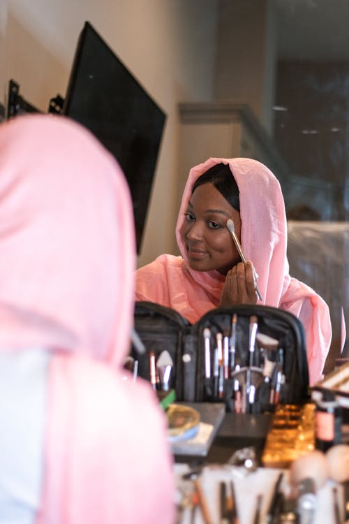 Woman in Pink Hijab doing her Makeup