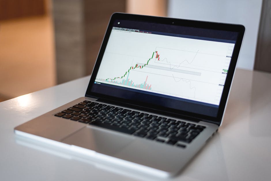 Does Acorns Actually Help With Spare Change Growth? Close-up of a laptop showing a financial trading graph, ideal for finance and technology themes.