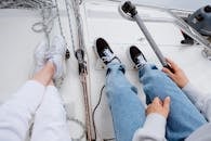 Person in Blue Denim Jeans and White Nike Sneakers
