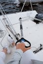 Person in White Shorts and White Sneakers Holding Black and Orange Handle Gray Metal Tool