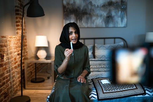 Muslim woman discussing feminine hygiene products during video presentation at home.