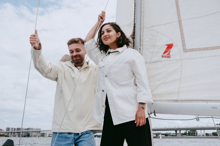 Man In White Dress Shirt Standing Beside Woman In Black Dress Shirt