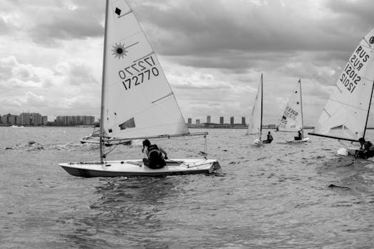 Monochrome photo of a sailing regatta with boats navigating open water.