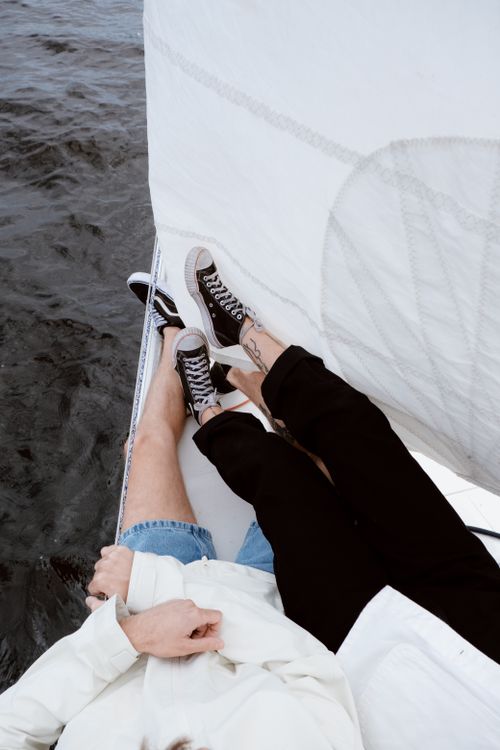 Free A couple enjoying a peaceful sailing trip, capturing leisure and romance. Stock Photo