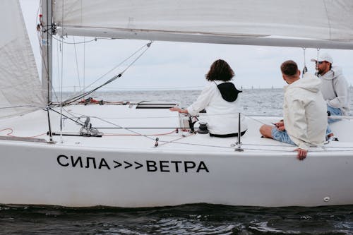 Man and Woman in White Boat on Sea